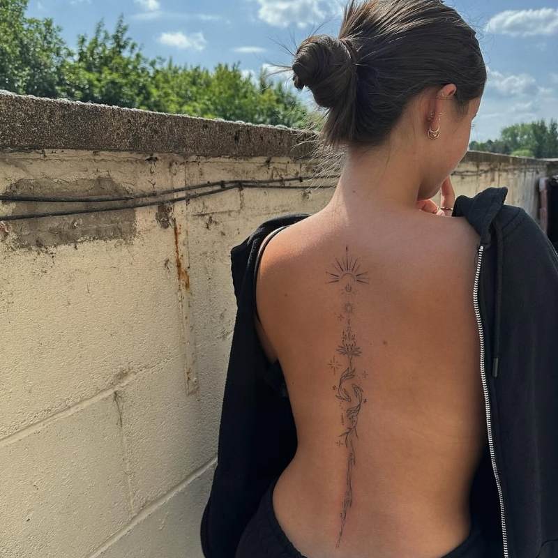 dainty celestial spine tattoo