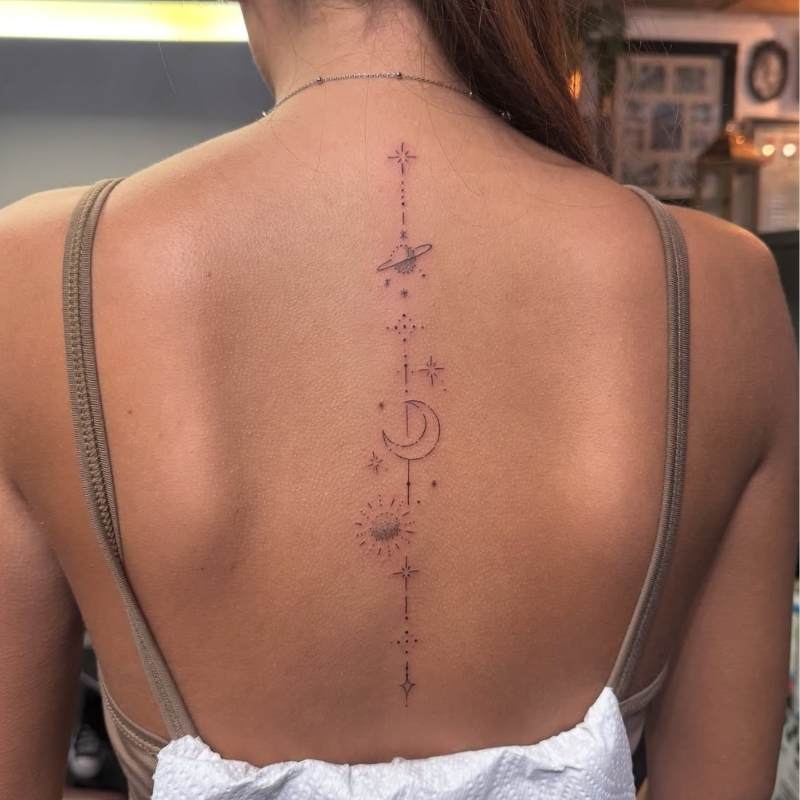dainty celestial spine tattoo